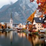 Hallstatt Austria – A picturesque village by a serene lake surrounded by autumn foliage